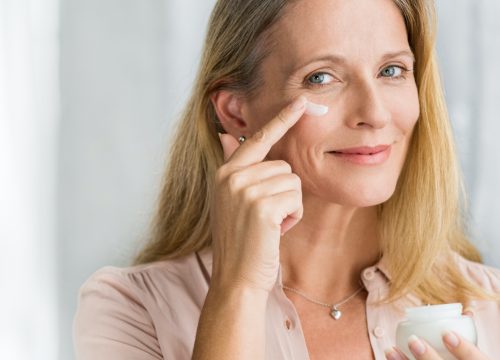 Middle age woman applying skin care products